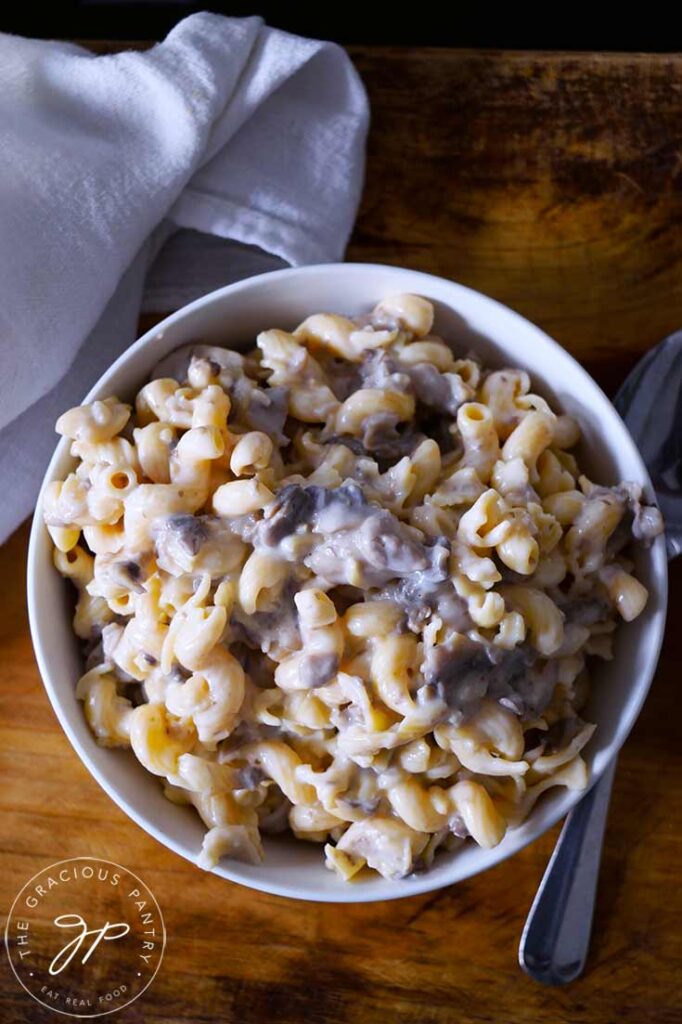 An overhead view looking down into a white bowl filled with Creamy Garlic Mushroom Pasta.