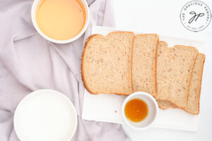French Toast Sticks Recipe ingredients measured and in individual bowls and platter.
