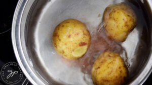 Potatos and salt in a pot of water.