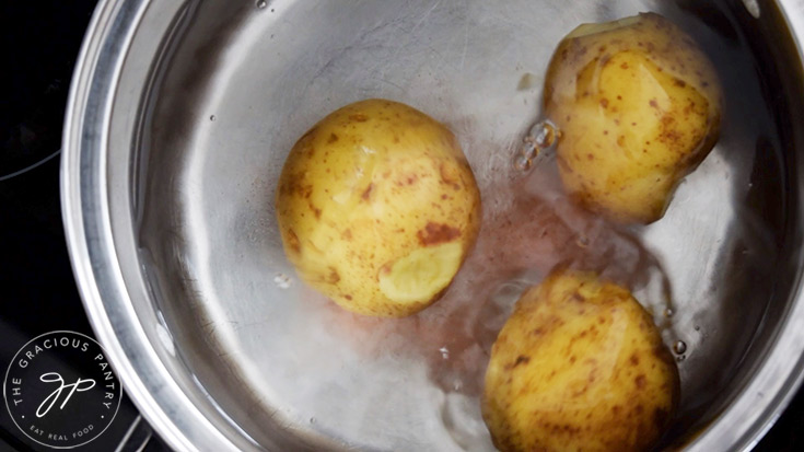 Potatos and salt in a pot of water.