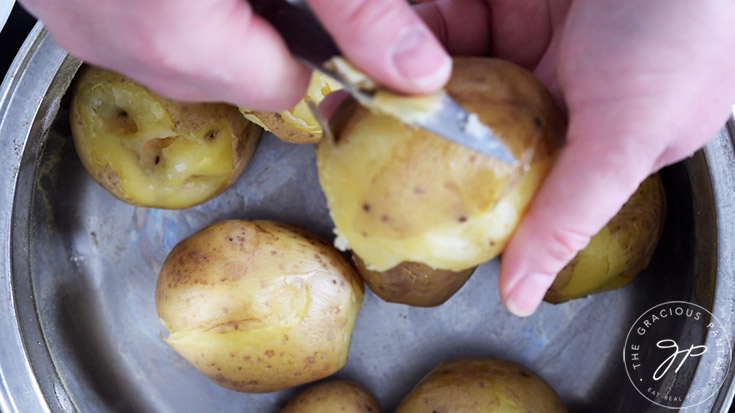 Peeling cooked and cooled potatoes.