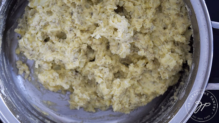 The finished smashed potatoes sitting in a pot.