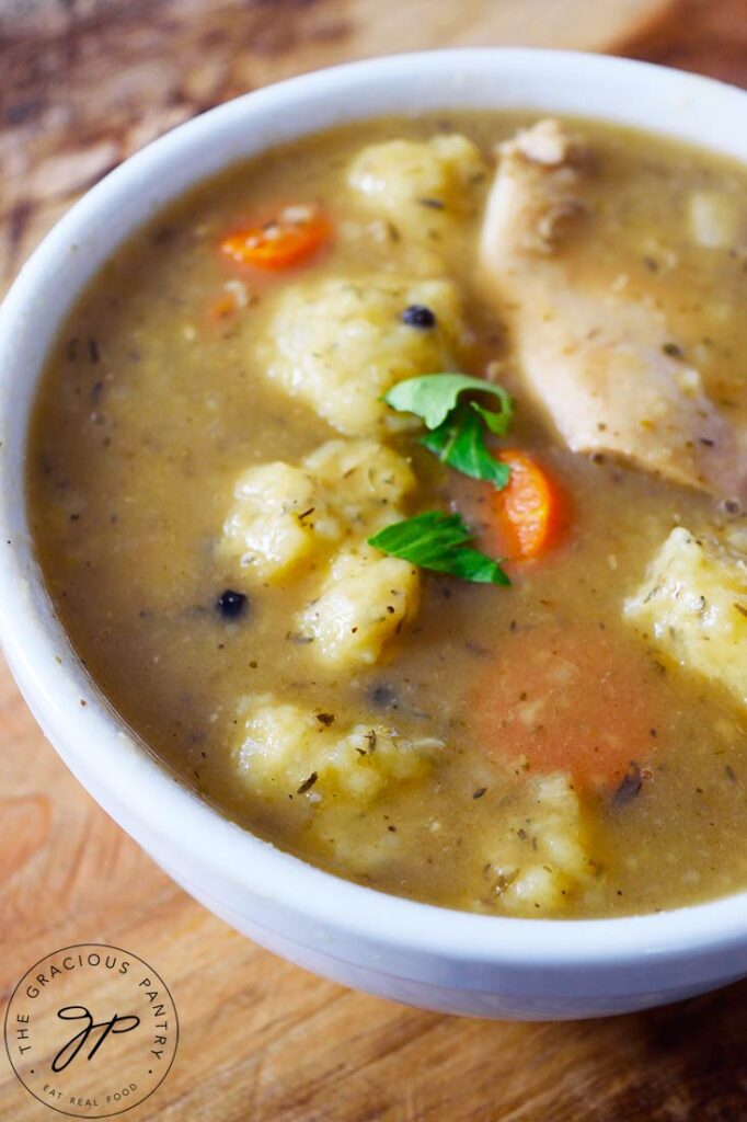 A closeup of a white bowl filled with German Potato Dumpling Soup.