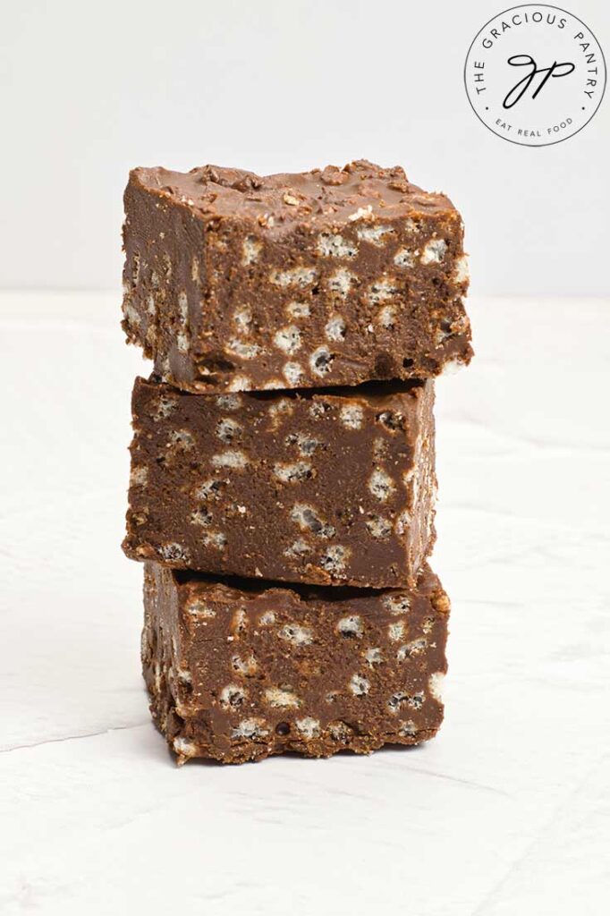 Three Homemade Crunch Bars stacked high on a white background.