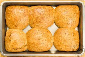 Just baked hot cross buns cooling in a baking pan.