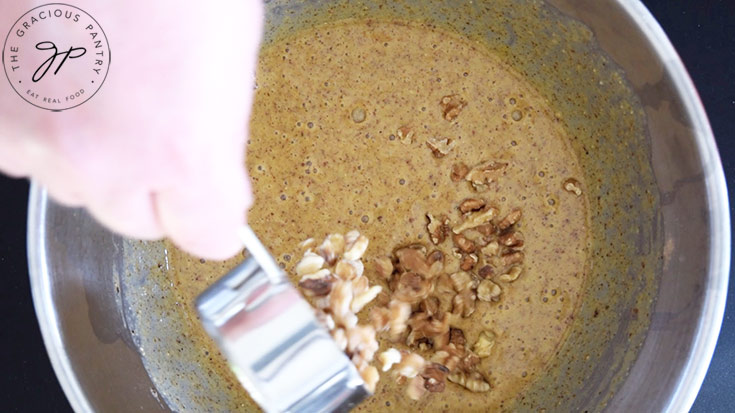 Adding walnuts to Pecan Butter Bread batter.