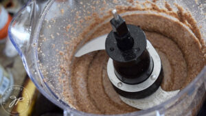 Just blended pecan butter sitting in a food processor.
