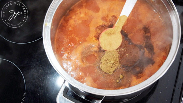 Adding spices to the Ranch Style Beans base.