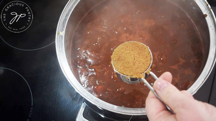 Adding sweetener to the Ranch Style Beans.