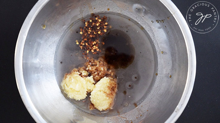 Sauce ingredients sitting unmixed in a mixing bowl.