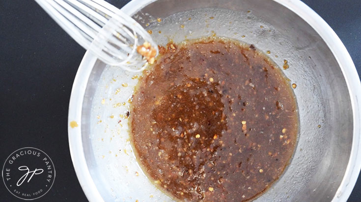 Sauce ingredients whisked together in a mixing bowl.