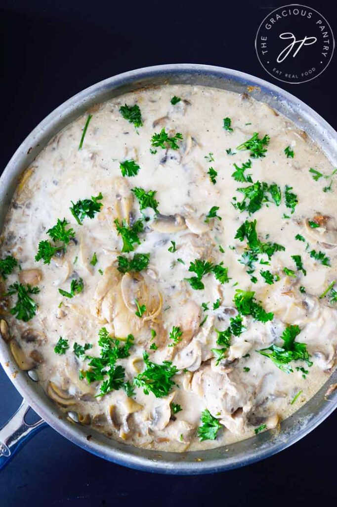 An overhead view looking down into a skillet filled with this Creamy Garlic Mushroom Chicken recipe.