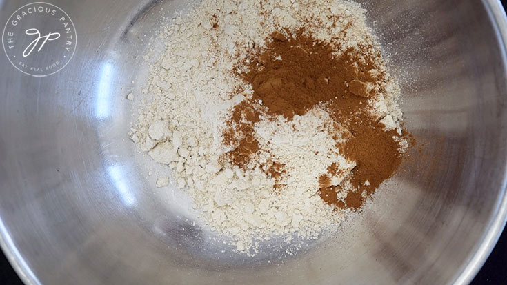 Flour, salt and ground cinnamon in a mixing bowl, unmixed.