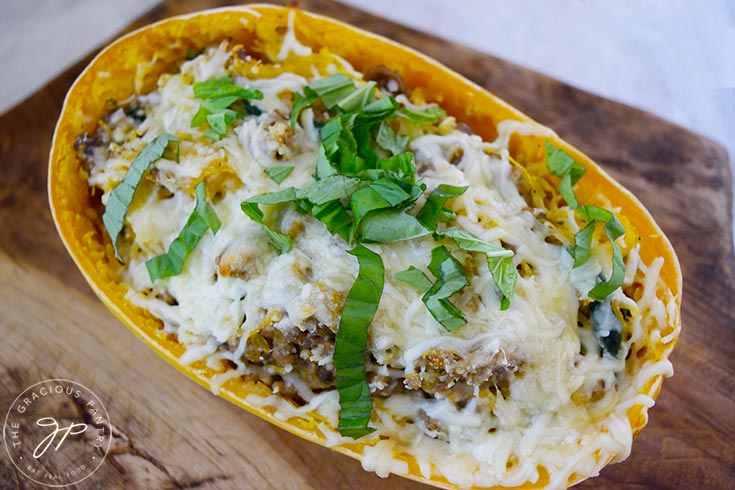 A finished Italian Spaghetti Squash Boat sitting on a cutting board.