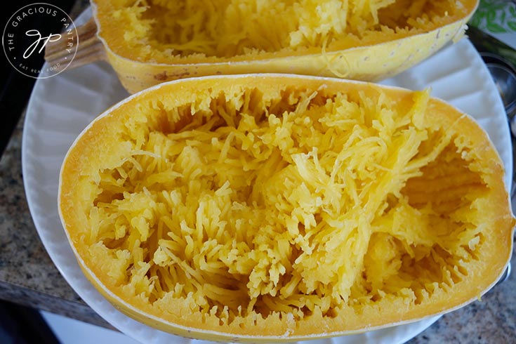 Cooked spaghetti squash that has had the "spaghetti" scraped.