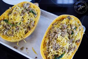 Italian Spaghetti Squash Boats filling stuffed into two empty spaghetti squash shells.