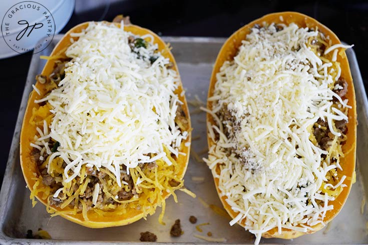 Two Italian Spaghetti Squash Boats topped with grated mozzarella.