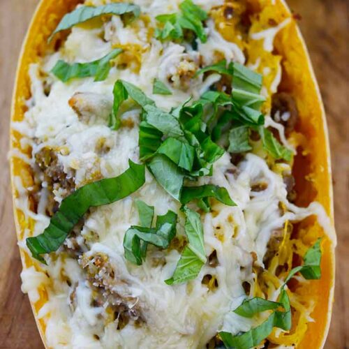 An overhead view of a single Italian Spaghetti Squash Boat sitting on a cutting board.