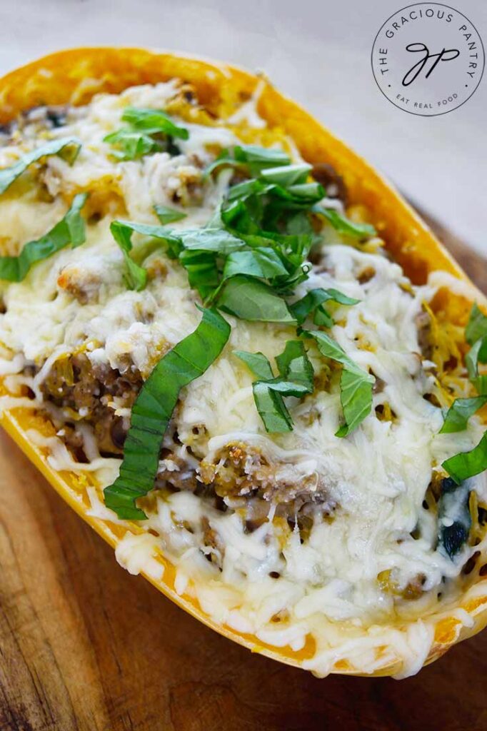 Side view of one of the Italian Spaghetti Squash Boats sitting on a cutting board.