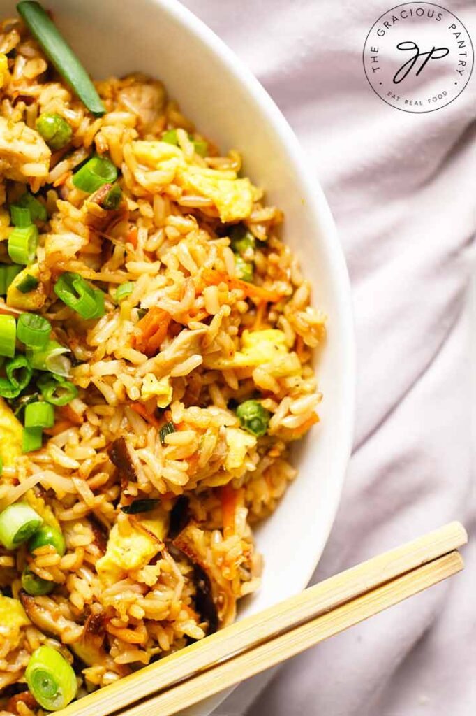 An overhead view looking down into a white dish filled with Healthy Pork Fried Rice.