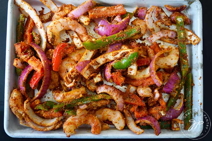 Sheet Pan Shrimp Fajitas Recipe ingredients spread out over a sheet pan.