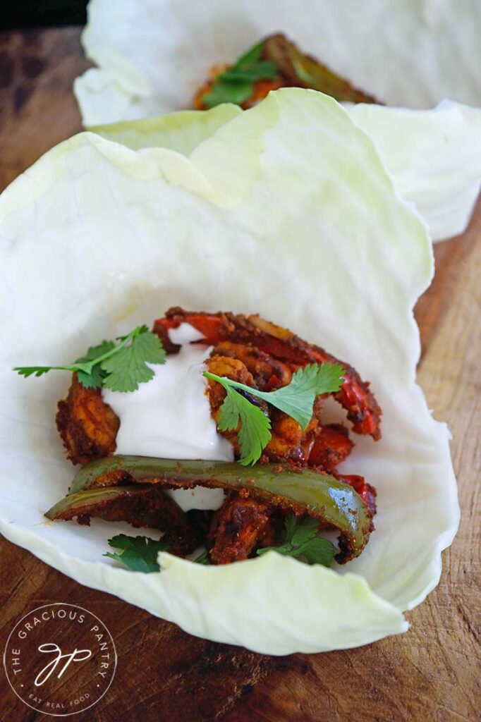 Two Sheet Pan Shrimp Fajitas in cabbage leaves instead of corn tortillas.