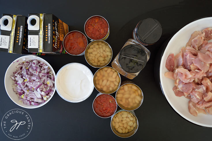 Ingredients for Crockpot White Chicken Chili sitting on a black background.