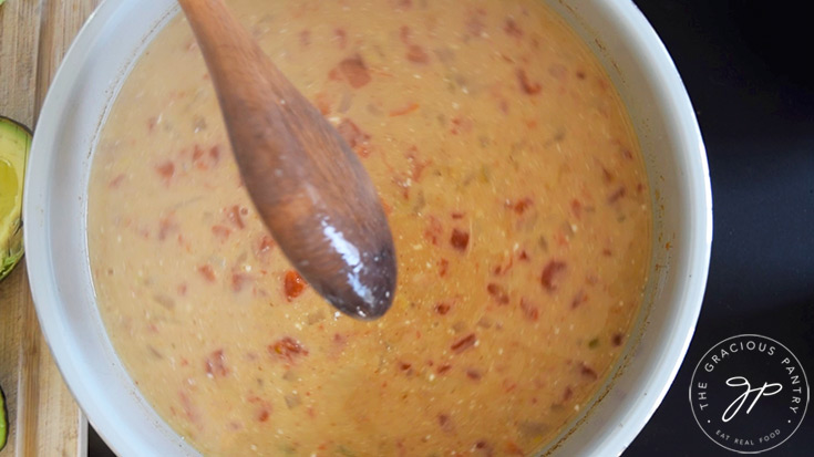 The finished chili in a crock after having yogurt stirred into it.