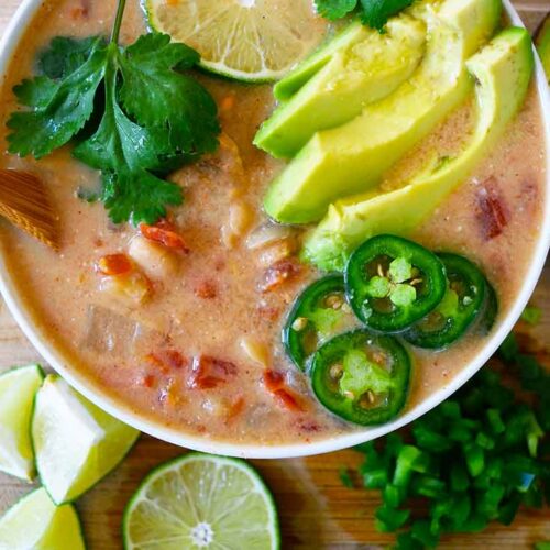 An overhead view looking down into a white bowl filled with Crockpot White Chicken Chili.