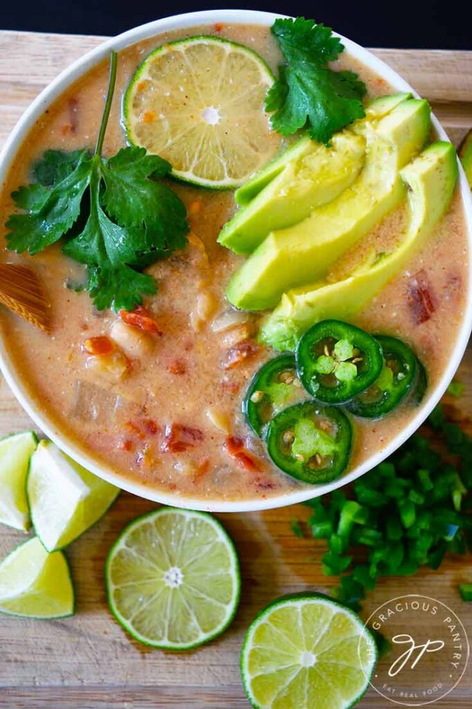 An overhead view looking down into a white bowl filled with Crockpot White Chicken Chili.