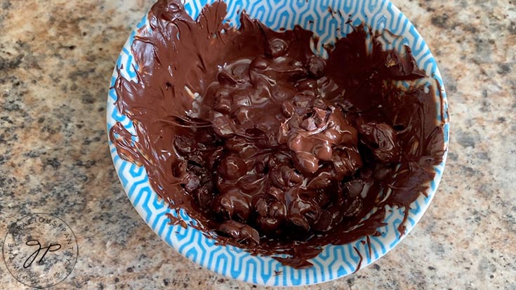 Partially melted chocolate chips in a small bowl.