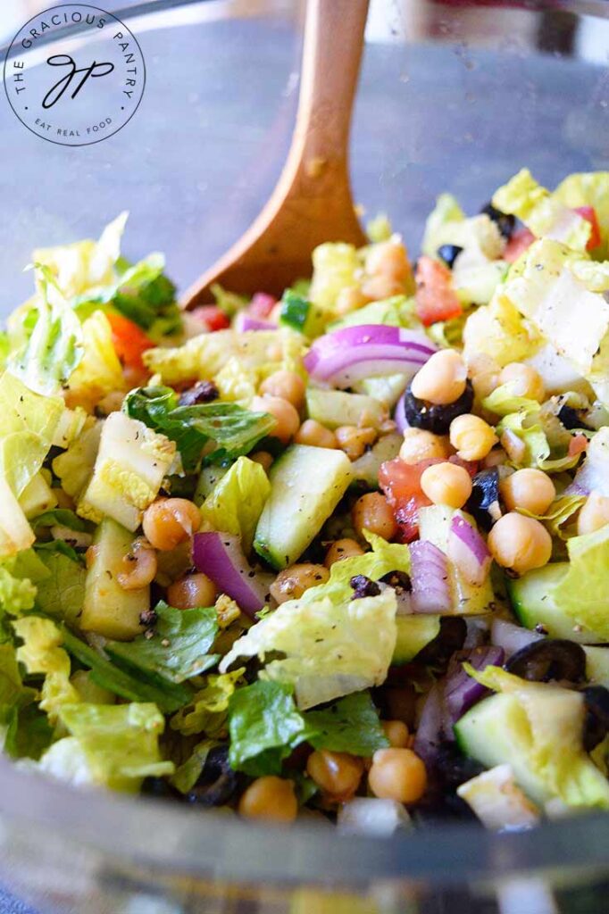 A closeup looking into a clear, plastic bowl filled with Italian Chopped Salad.