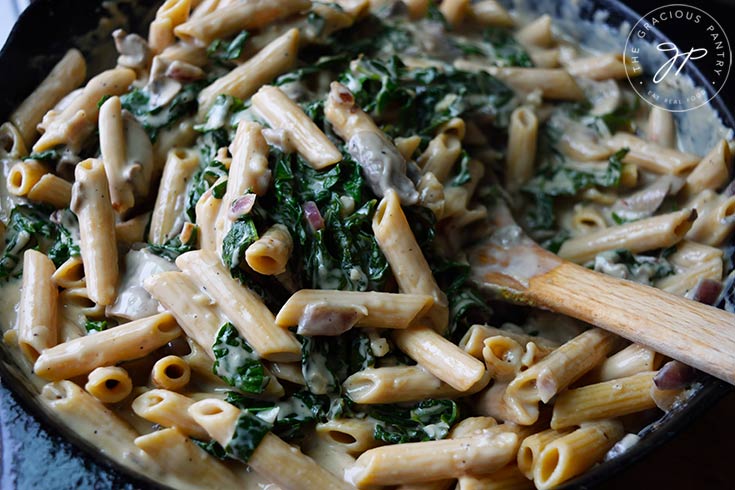 A skillet full of just-made Creamy Kale And Mushroom Pasta.