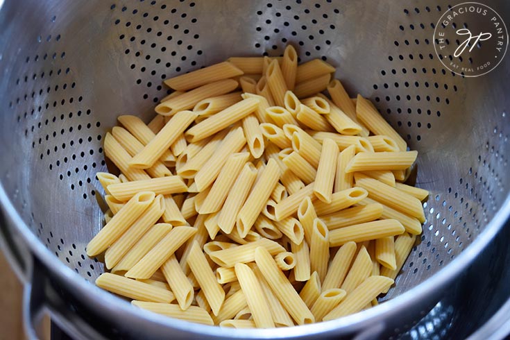 Cooked, drained pasta sitting in a colander.