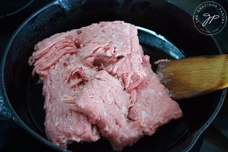 Ground turkey in a cast iron skillet.