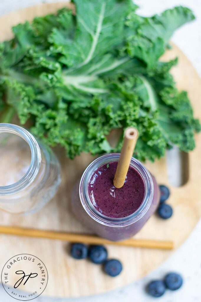 An overhead view looking down into a small milk jug filled with this Kale Blueberry Smoothie Recipe.