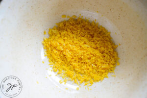 A bowl of freshly grated lemon zest.