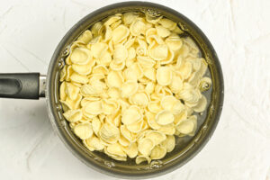 Orecchiette Pasta cooking in a pot of salted water.