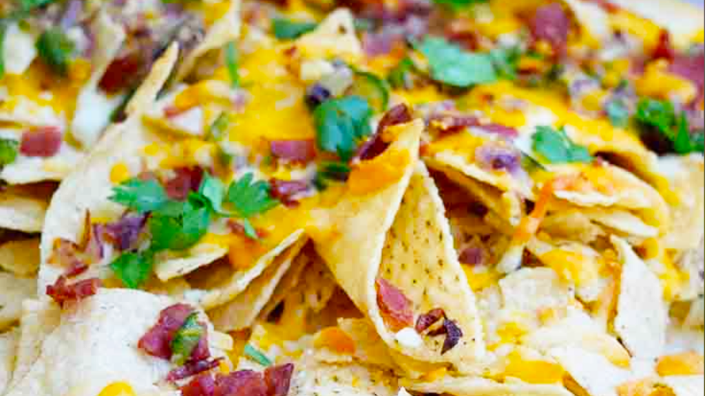 A closeup of Bacon Jalapeno Nachos garnished with fresh cilantro.