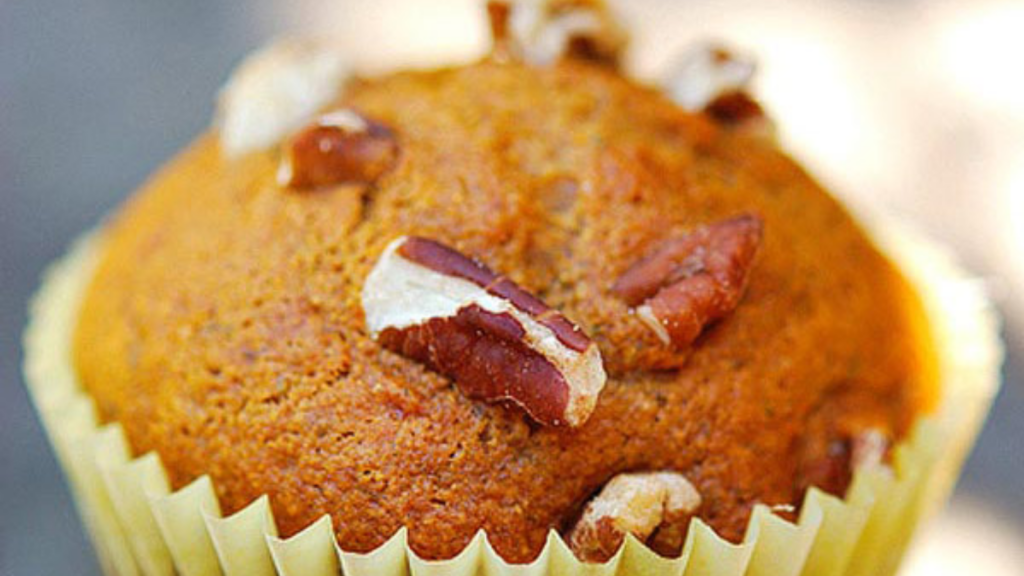 A banana muffin in a yellow muffin liner.