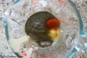 Dressing ingredients for this cauliflower salad recipe in a glass measuring cup.