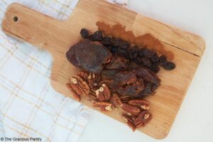 Cherry Pie Lara Bars Recipe ingredients laying gathered on a wood cutting board.