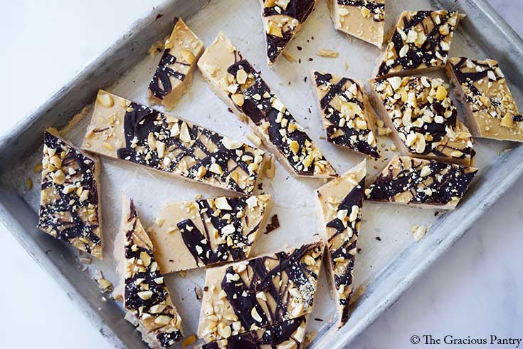 An overhead view of a sheet pan holding pieces of Chocolate Peanut Butter Frozen Yogurt Bark.