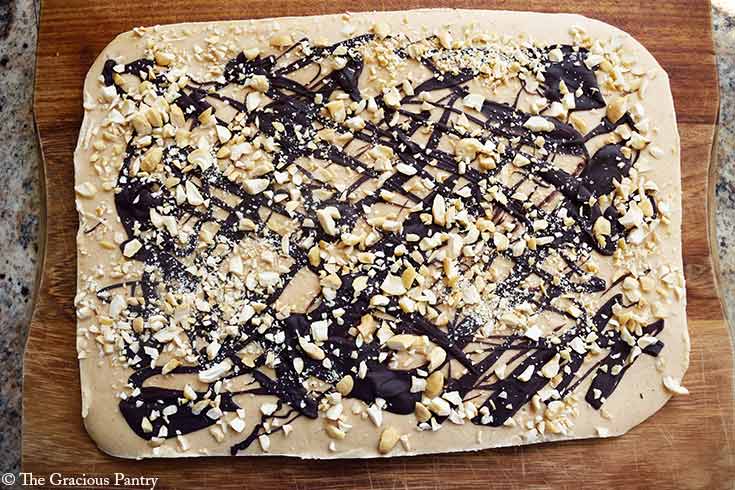 Chocolate Peanut Butter Frozen Yogurt Bark laying on a cutting board.