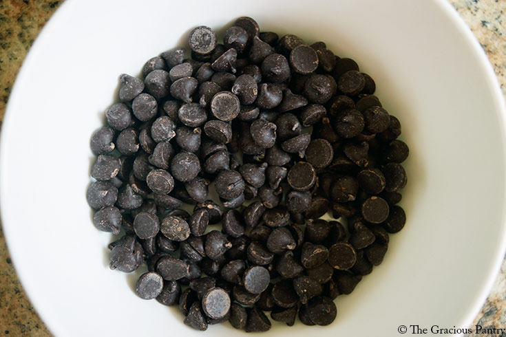 Chocolate chips in a white bowl.