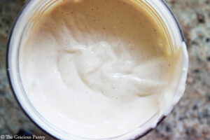 Blended yogurt, peanut butter and sweetener in a blender tumbler.