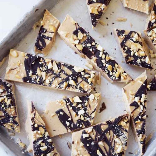 An overhead view of Chocolate Peanut Butter Frozen Yogurt Bark pieces on a cookie sheet.