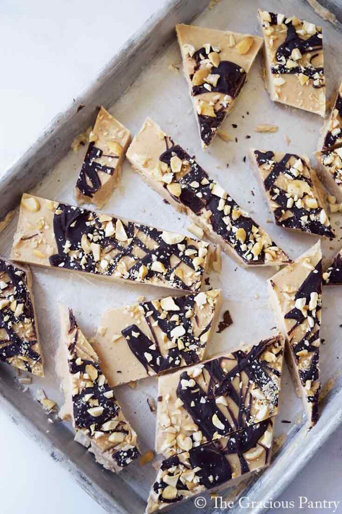 An overhead view of Chocolate Peanut Butter Frozen Yogurt Bark pieces on a cookie sheet.