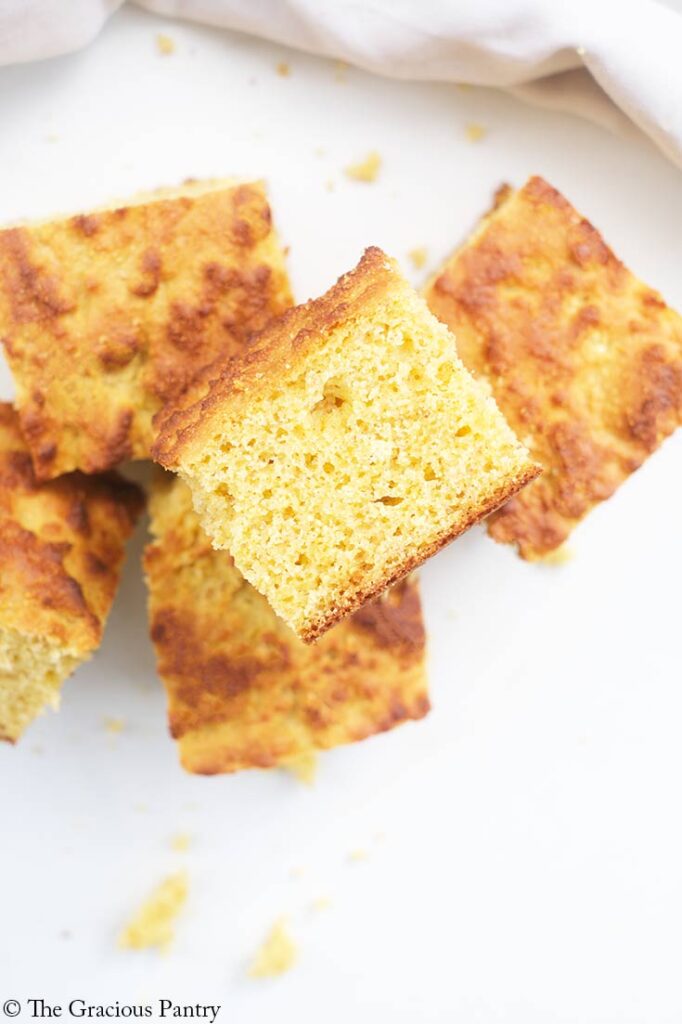 A closeup of a pile of cut cornbread pieces.