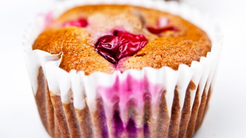 A single cranberry muffins against a white background.